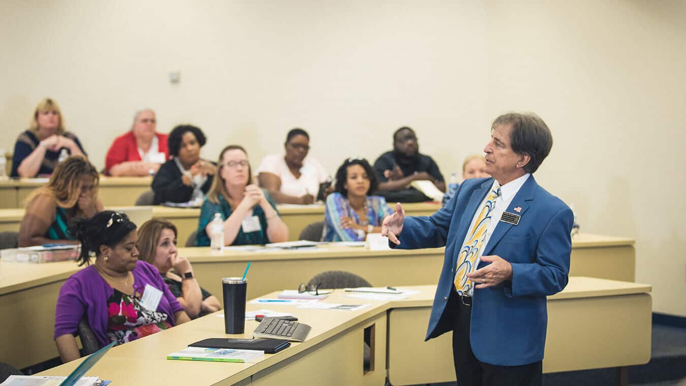 A professor teaching a class: Pursue an Ed.S. in Educational Leadership - Adult Education at Regent University.