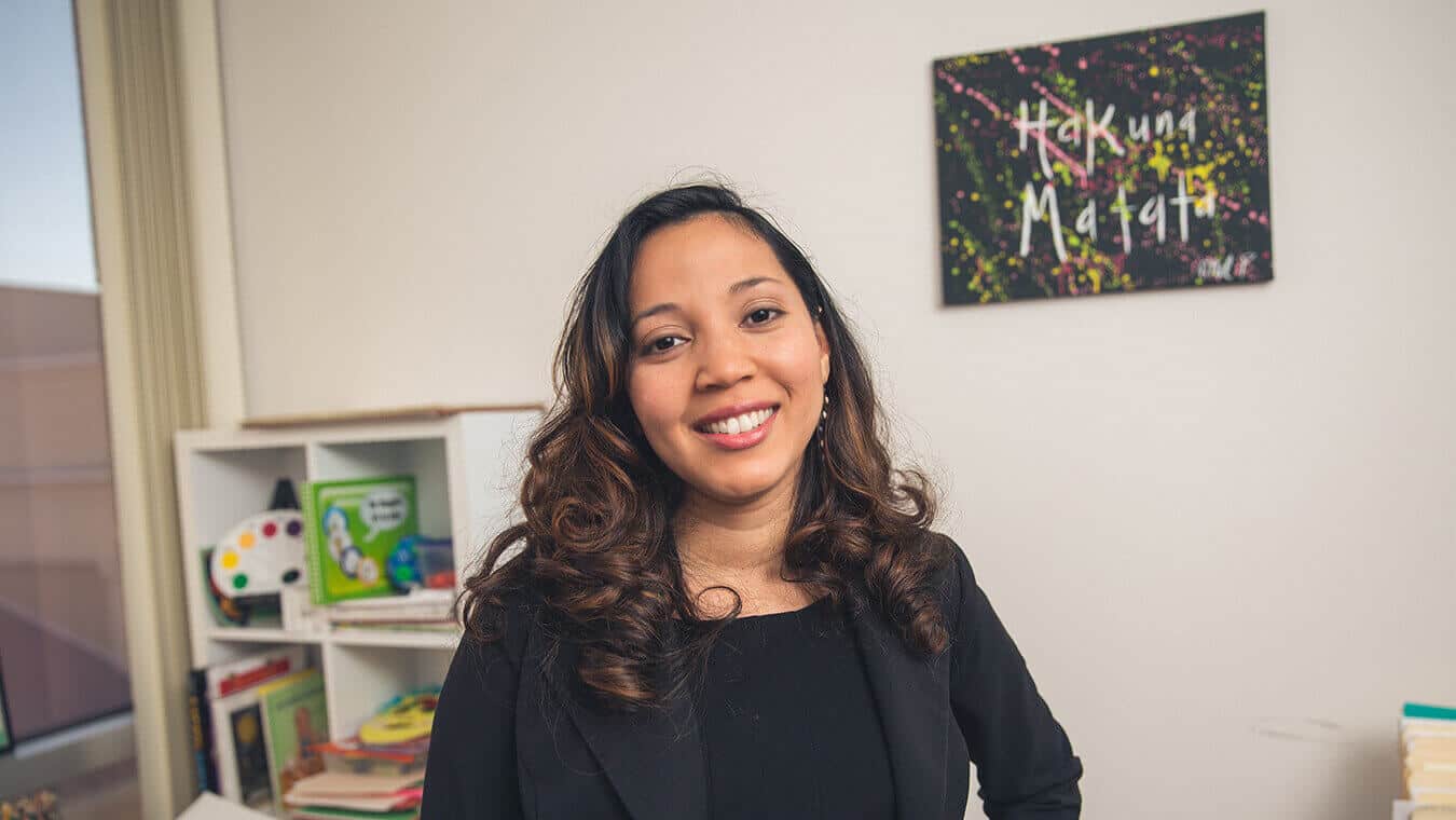 An alumna of Regent's online MA in Human Services – Criminal Justice and Ministry program smiling in her office