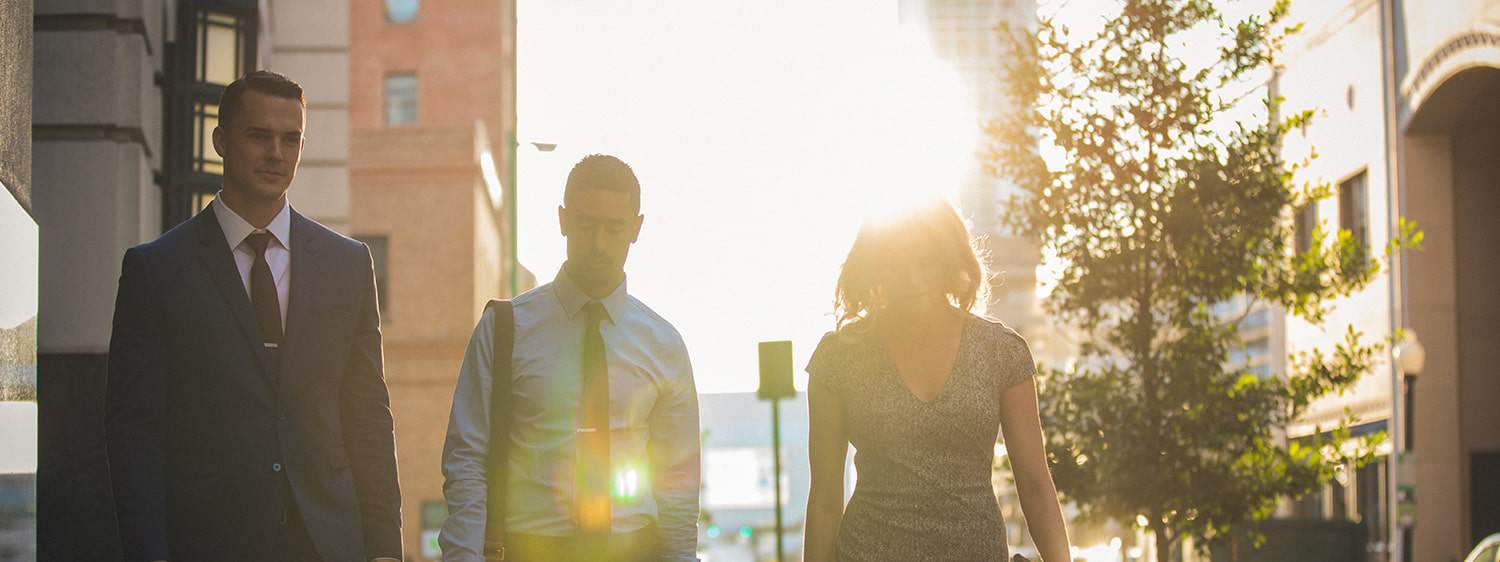 Three professionals walking in the city.