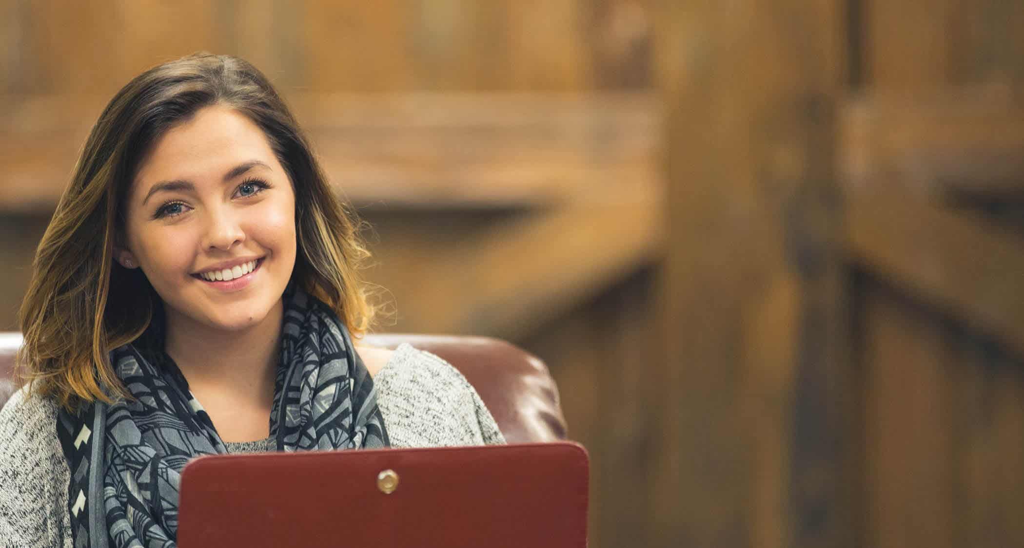 A student with her laptop at Regent, a Christian college that offers degrees online and in Virginia Beach, VA 23464.