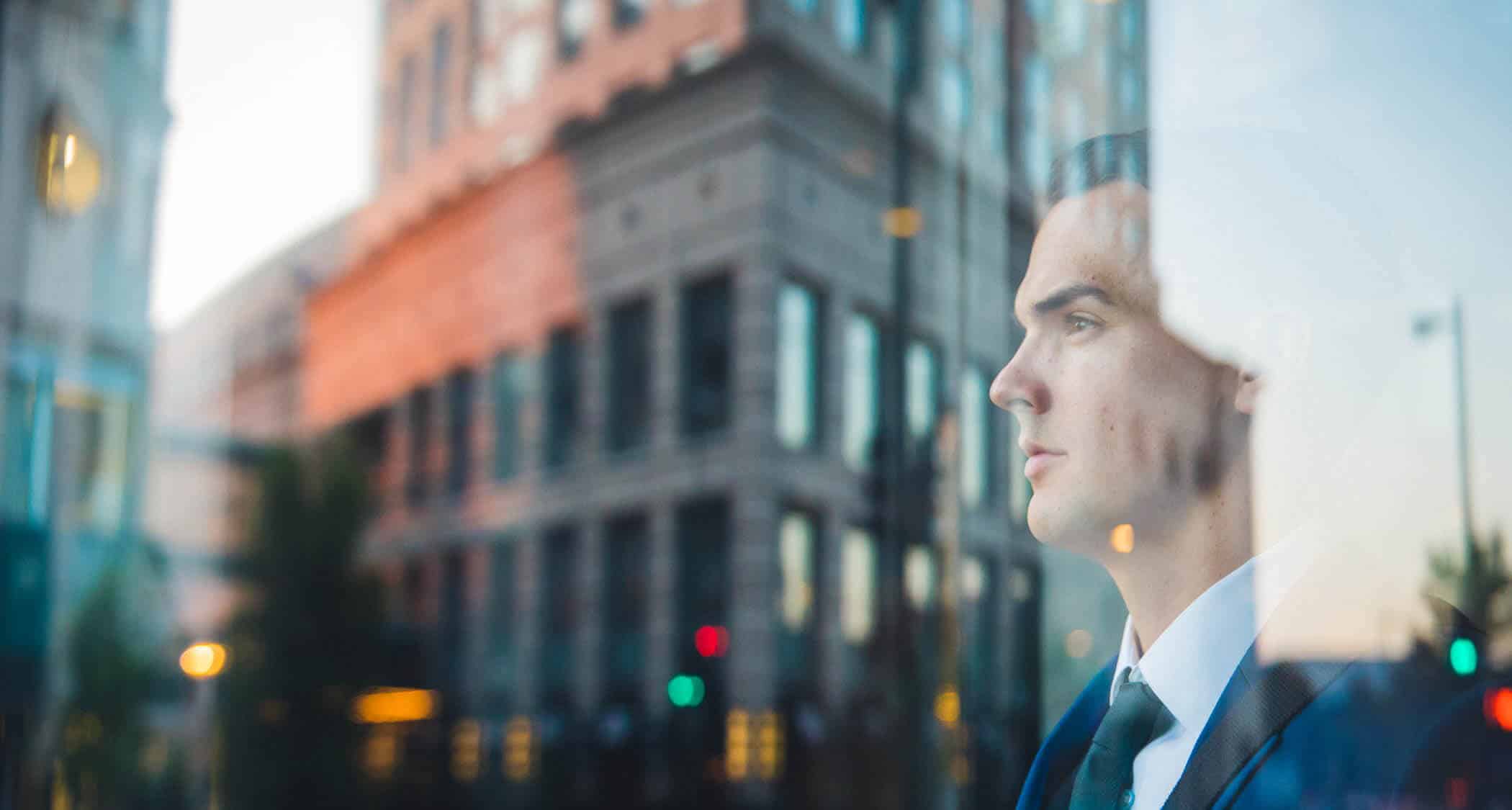 A person looking at a building in Norfolk, Virginia: Explore Regent's Doctor of Strategic Leadership program.