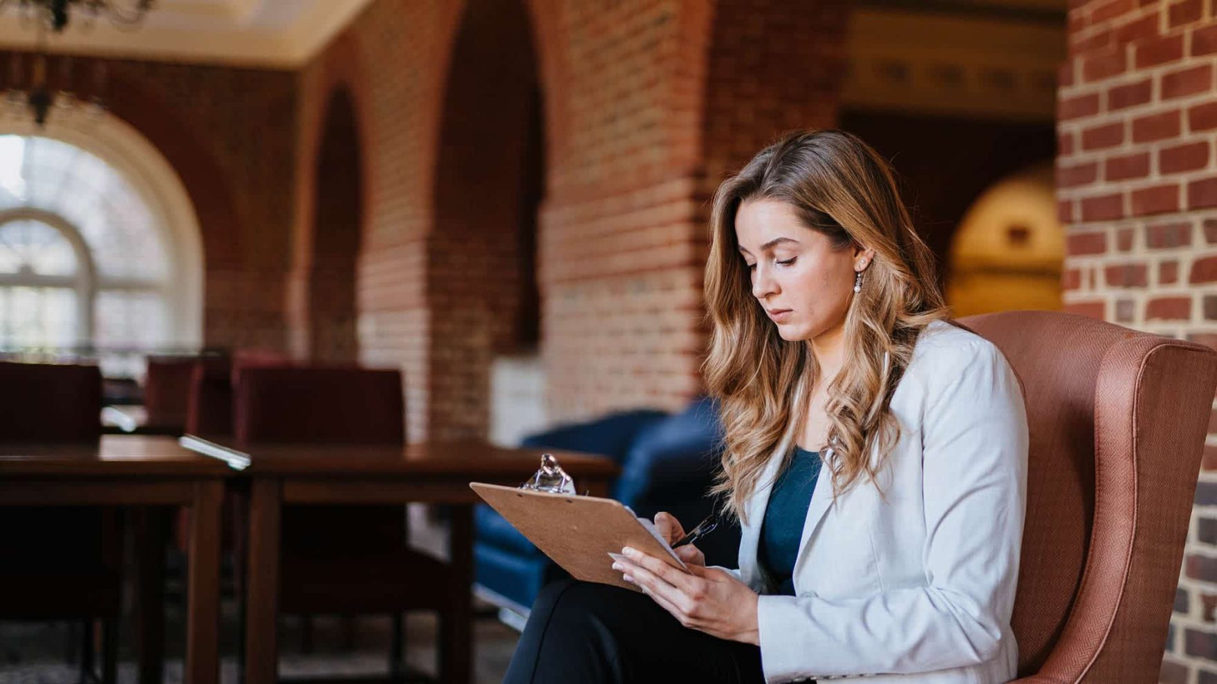 A student taking notes at Regent, a university that offers an undergraduate certificate in psychology online and in Virginia Beach.