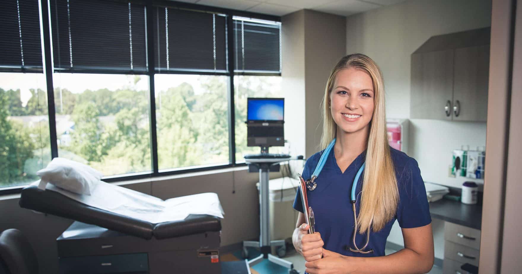 A nurse with a patient in the background