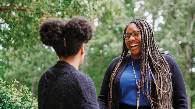 Two students talking outside at Regent University.