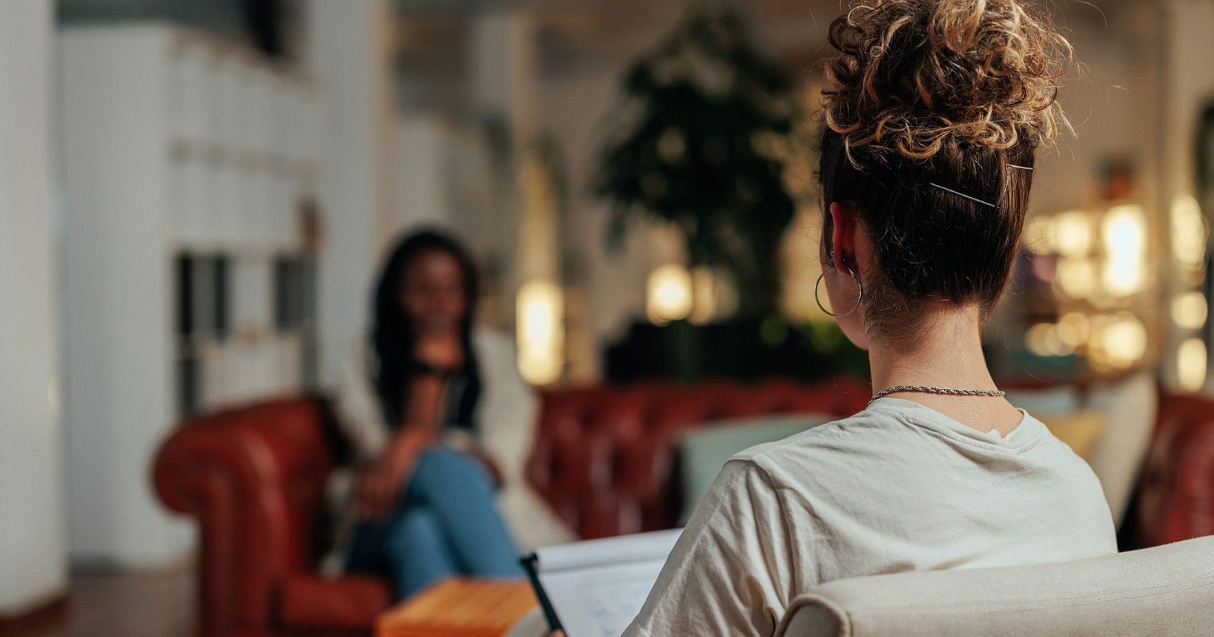 Mental Health Clinician talking to a client: Explore Regent University's additions counseling programs.