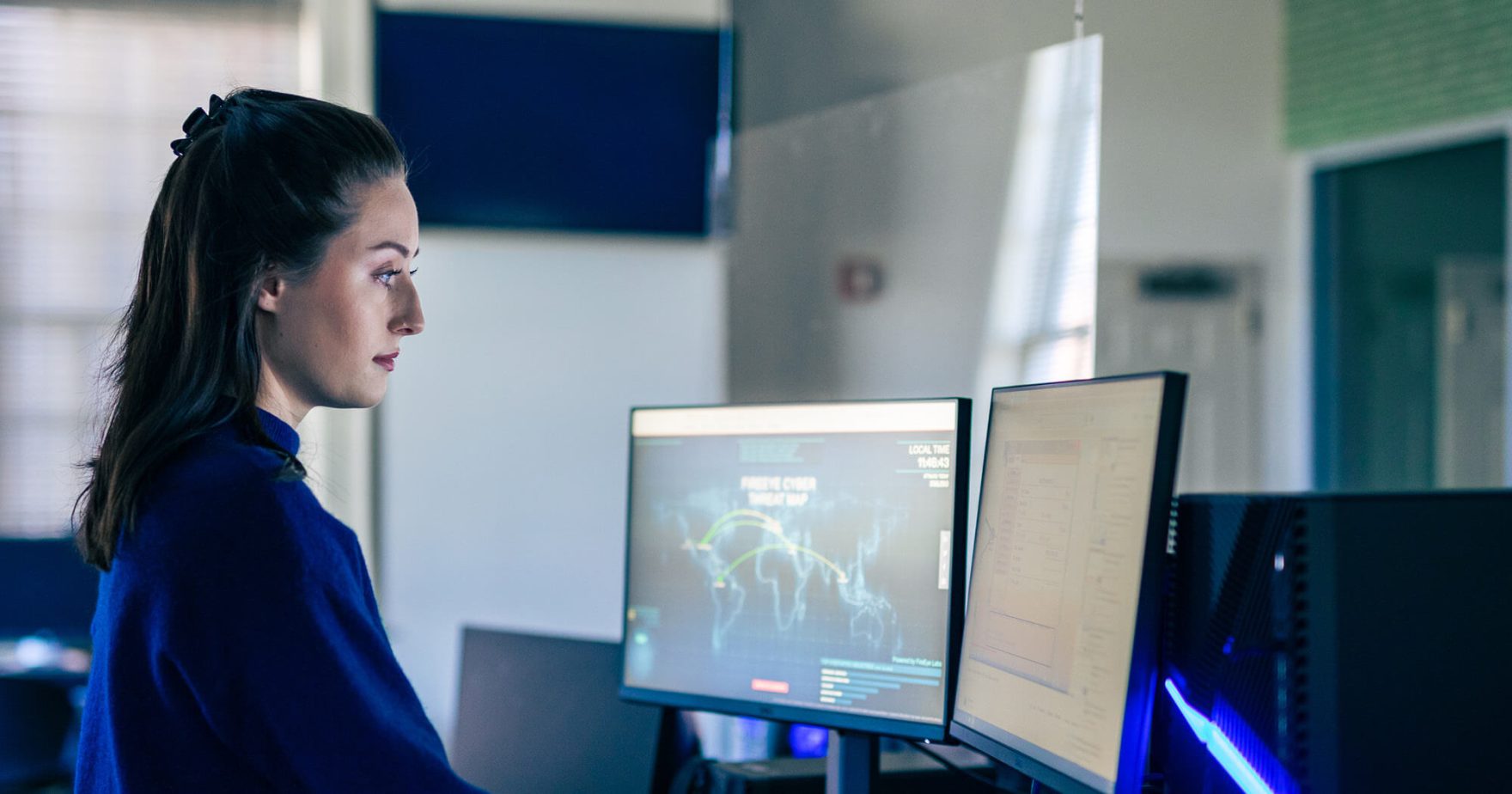 Student working on a computer: Learn More about Regent University programs.