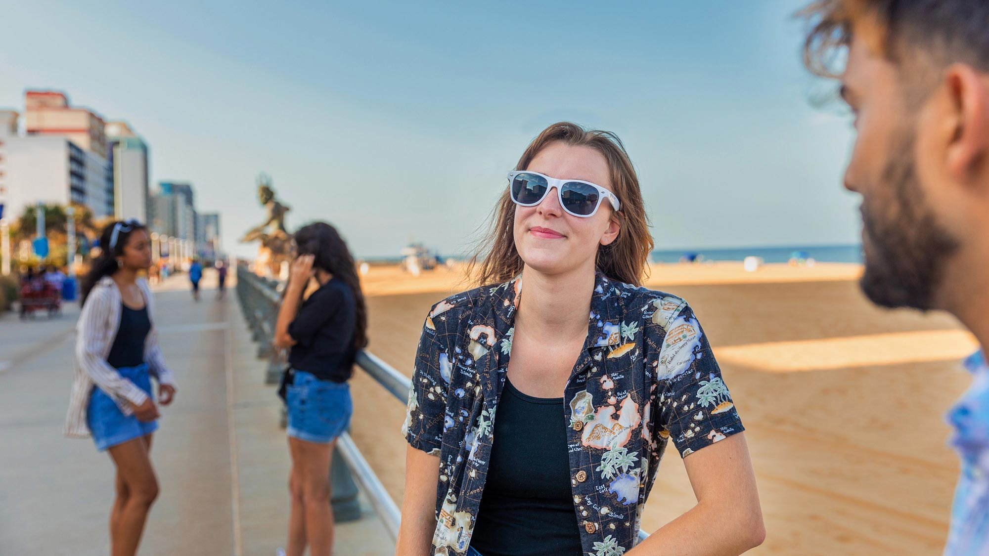 Four Regent University students enjoying the oceanfront in Virginia Beach