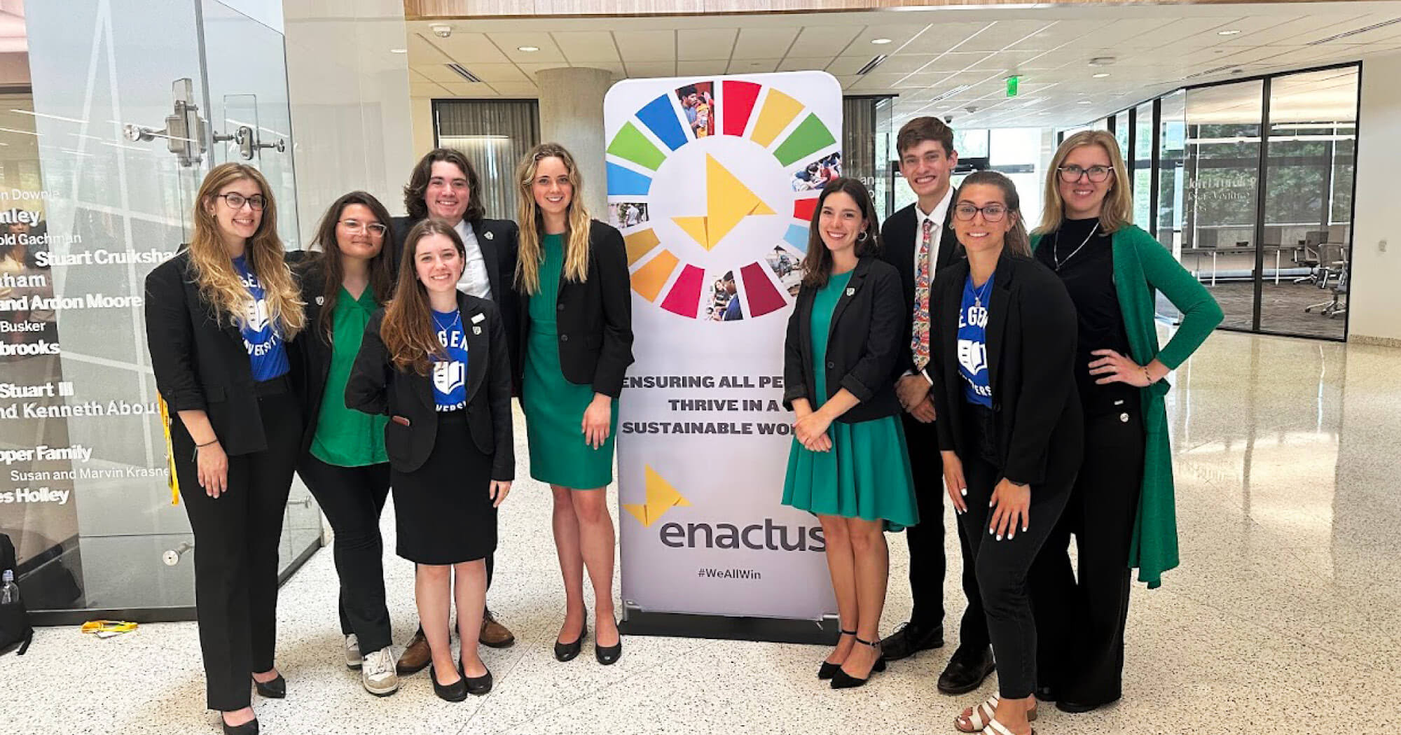 Regent University Enactus team posing together at the National Competition in formal attire.