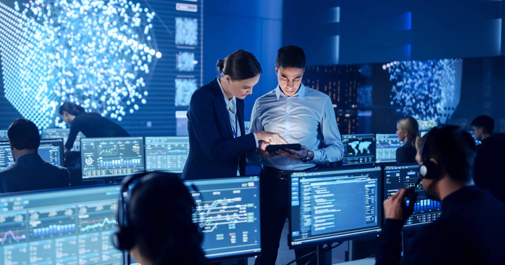 employees working on the computers in a cybersecurity center.